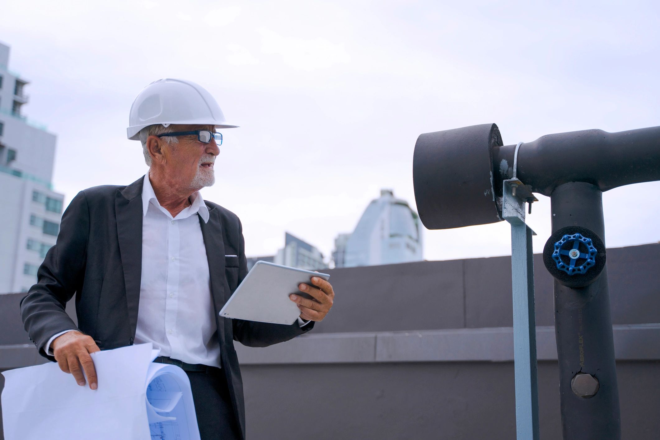 Engineer inspecting rooftop representing municipal roofing oversight