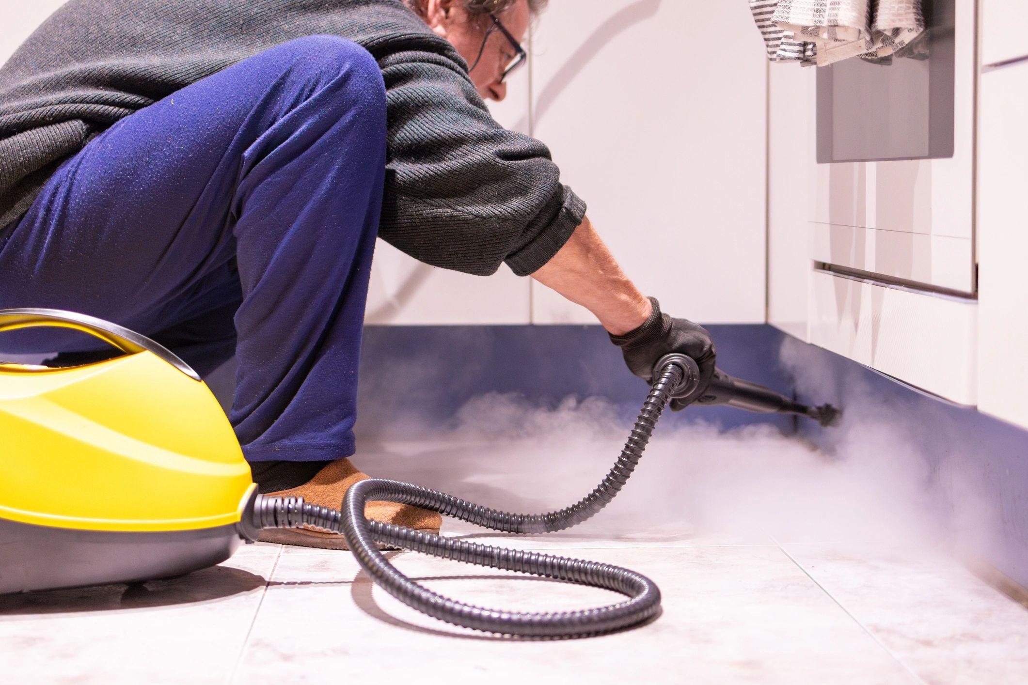 Homeowner using a cleaning machine representing water mitigation and recovery